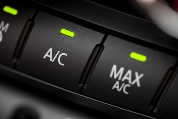 Color detail with the air conditioning button inside a car.